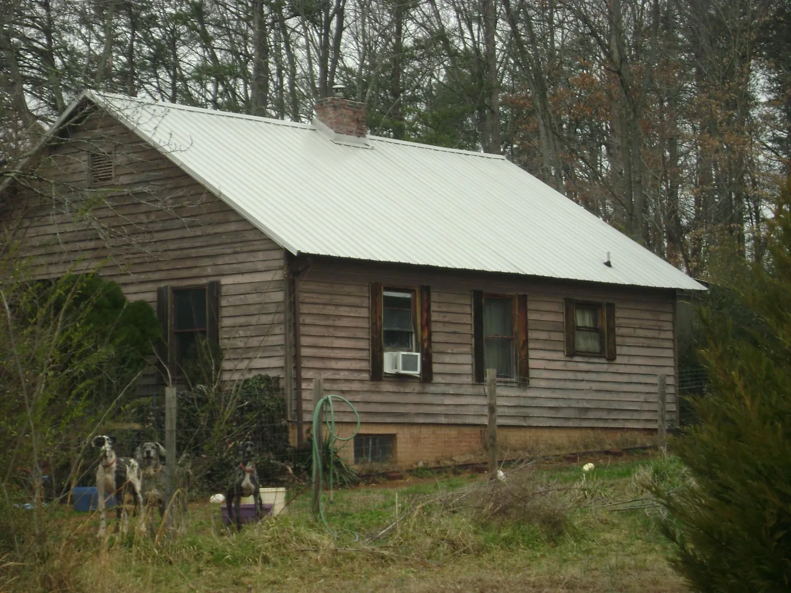 White metal roof on an old wood sided farmhouse, from a Metal Roof Installation job in Kilbourne